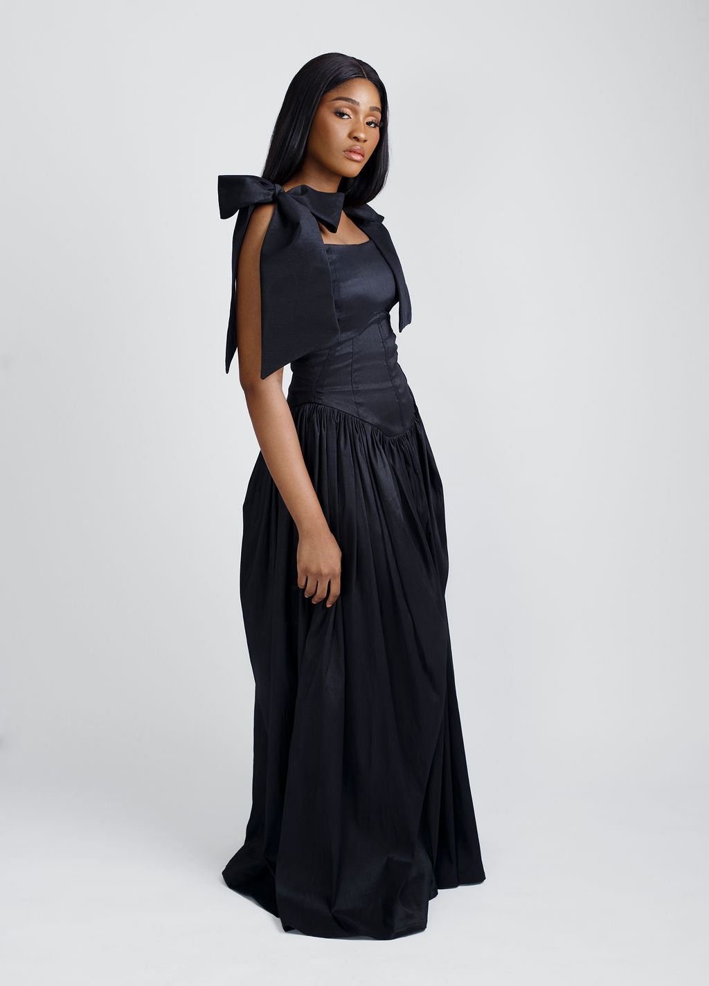 Black maxi dress with elegant bow straps, designed for modern women who love timeless fashion. This versatile dress combines minimalist style with luxurious comfort, perfect for evening events, formal occasions, or chic everyday wear. Shop now for trendy women's clothing at Kaiiko and Virgo.