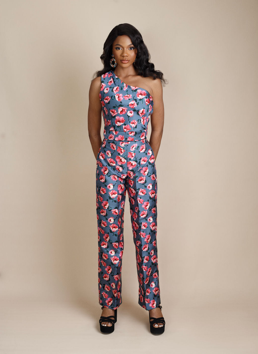 Stylish gray floral one-shoulder (monostrap) pant set adorned with soft pink flower patterns. This trendy and elegant outfit combines comfort and femininity, making it perfect for brunch dates, garden parties, or casual chic outings. Shop this must-have women's fashion look at Kaiiko and Virgo