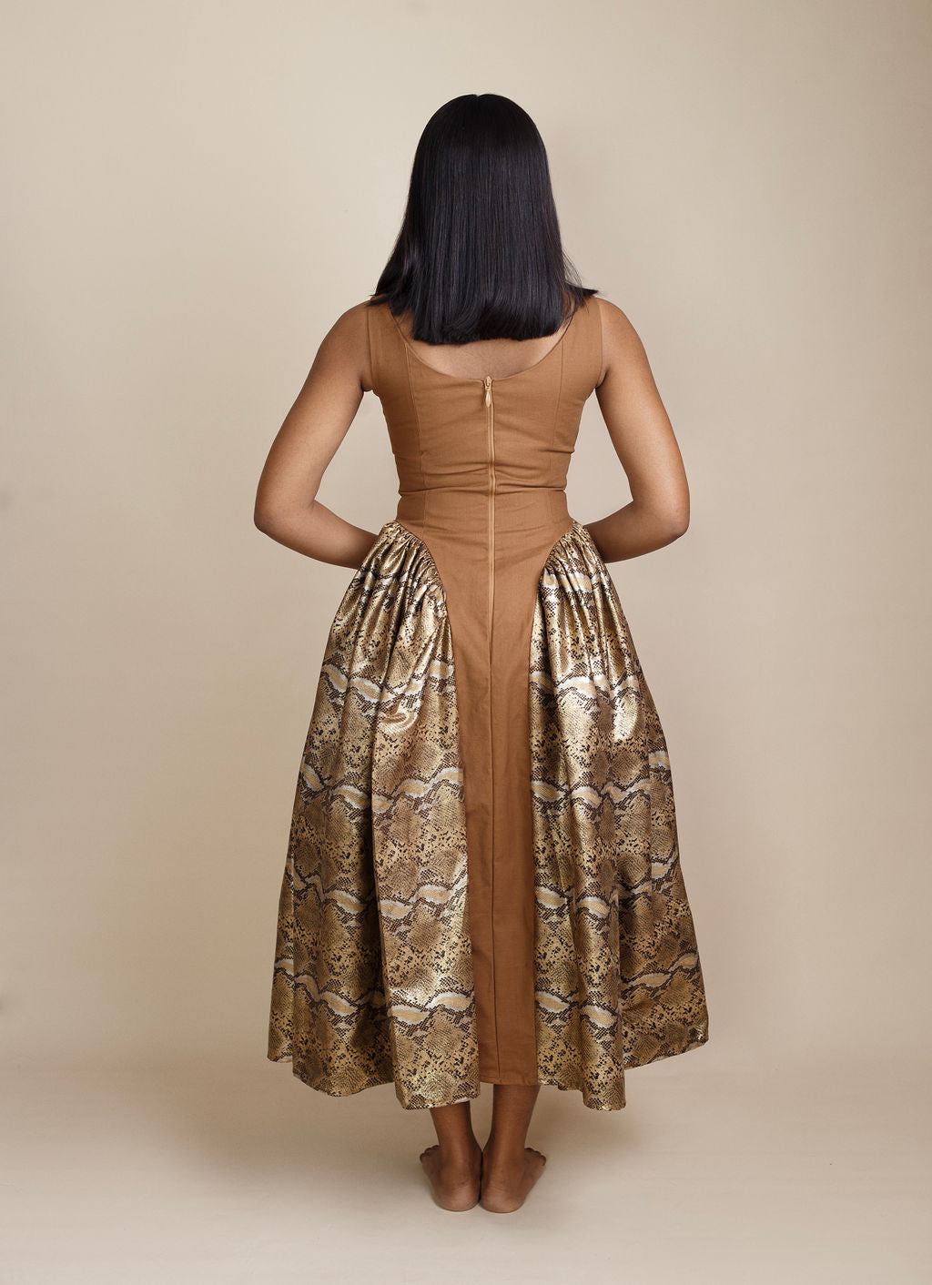 Back view of Elegant snake print and brown maxi dress, featuring bold animal patterns and earthy tones for a chic, on-trend 2025 fashion statement. Perfect for fashion-forward women attending parties, brunches, or upscale events. Shop the latest luxury women's dresses and trending fashion styles at Kaiiko and Virgo.